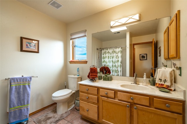 bathroom featuring vanity, curtained shower, tile patterned floors, and toilet