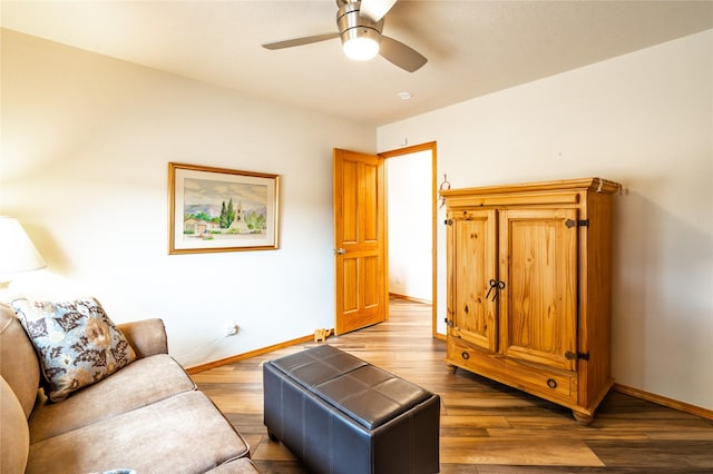 living room featuring hardwood / wood-style floors and ceiling fan