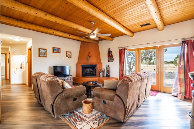 living room featuring hardwood / wood-style floors, a large fireplace, ceiling fan, wooden ceiling, and beam ceiling