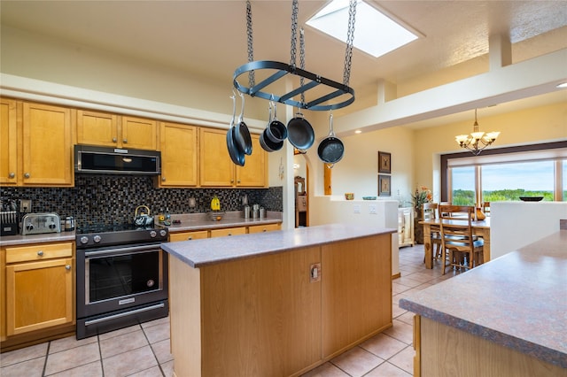 kitchen featuring light tile patterned flooring, tasteful backsplash, hanging light fixtures, electric range oven, and a kitchen island