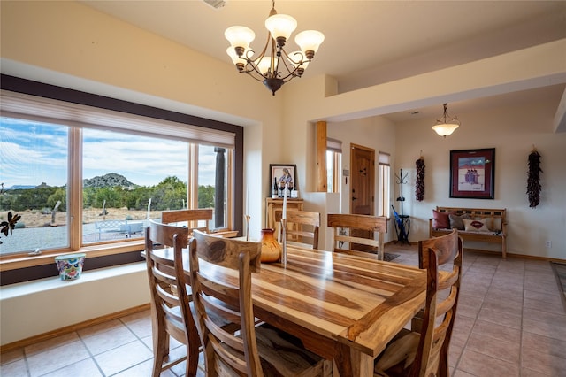 tiled dining space with a mountain view and a chandelier