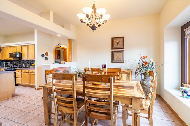 tiled dining space with a chandelier