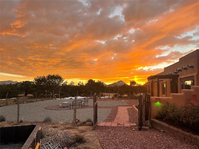 yard at dusk featuring a mountain view