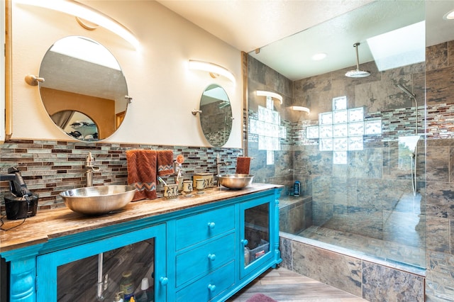 bathroom featuring vanity and tiled shower