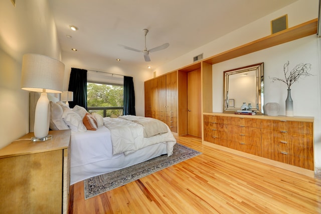 bedroom with ceiling fan and light hardwood / wood-style flooring