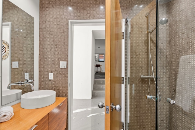 bathroom with tile walls, vanity, and an enclosed shower