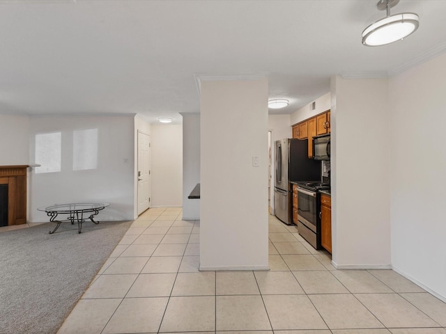 505 Oppenheimer Dr Unit 511, Los Alamos, NM 87544 - kitchen featuring appliances with stainless steel finishes, brown cabinetry, light tile patterned floors, and open floor plan