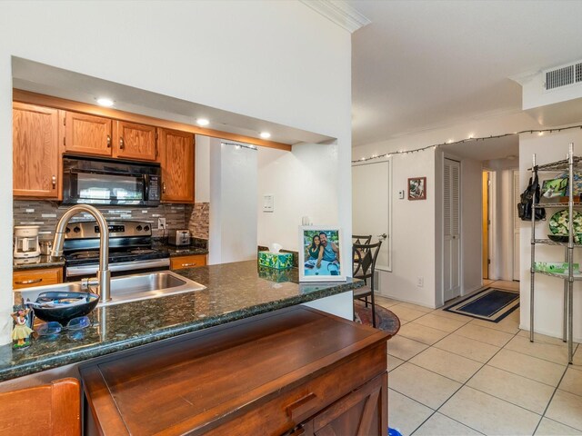 kitchen with visible vents, tasteful backsplash, stainless steel electric stove, black microwave, and light tile patterned floors