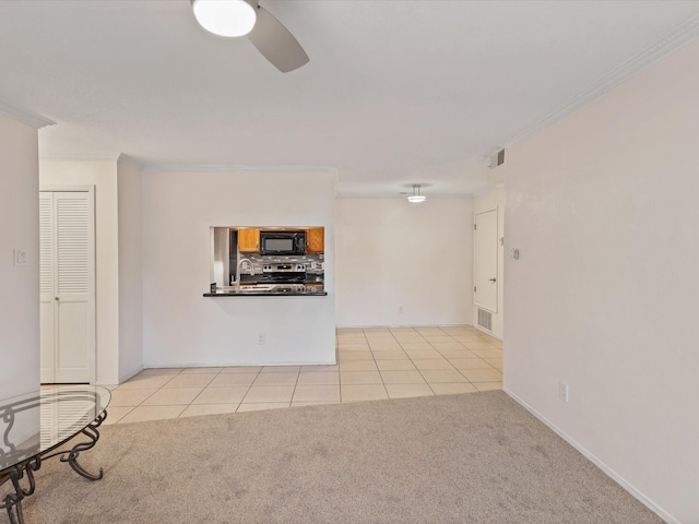 505 Oppenheimer Dr Unit 511, Los Alamos, NM 87544 - unfurnished living room featuring a sink, crown molding, a ceiling fan, light tile patterned flooring, and light colored carpet