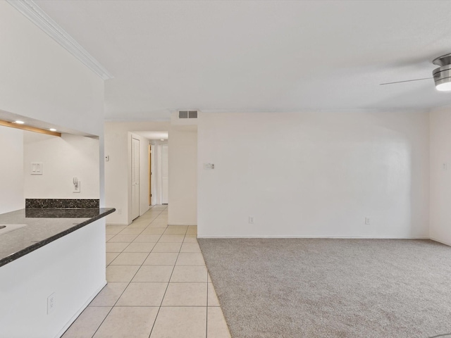 505 Oppenheimer Dr Unit 511, Los Alamos, NM 87544 - unfurnished room with light tile patterned floors, crown molding, baseboards, a ceiling fan, and light carpet