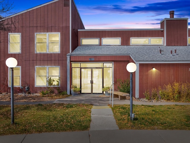 townhome / multi-family property featuring french doors and roof with shingles