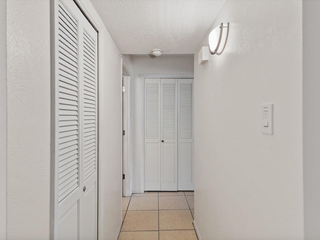 505 Oppenheimer Dr Unit 511, Los Alamos, NM 87544 - hall with light tile patterned floors, a textured ceiling, and baseboards