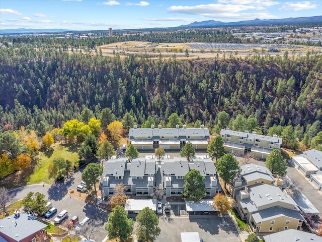 aerial view featuring a forest view, a residential view, and a mountain view