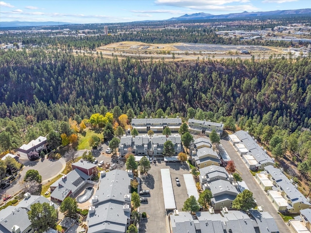 birds eye view of property with a residential view, a mountain view, and a forest view