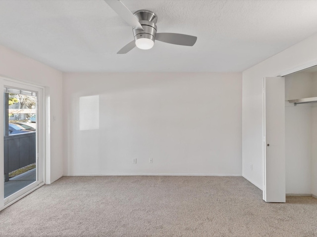 505 Oppenheimer Dr Unit 511, Los Alamos, NM 87544 - unfurnished bedroom featuring access to outside, carpet flooring, a ceiling fan, and baseboards