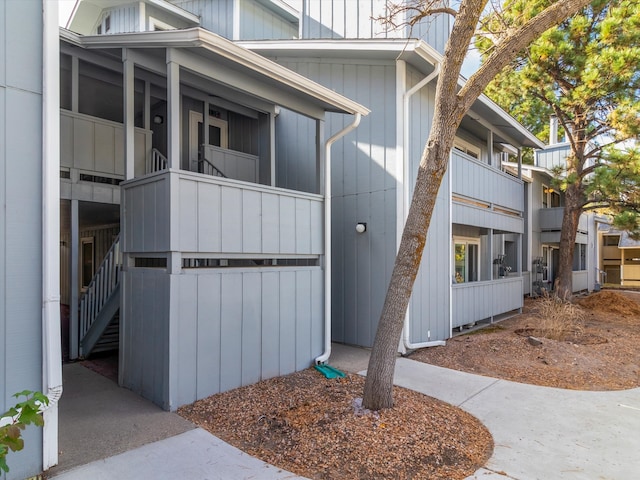 view of side of home featuring stairs