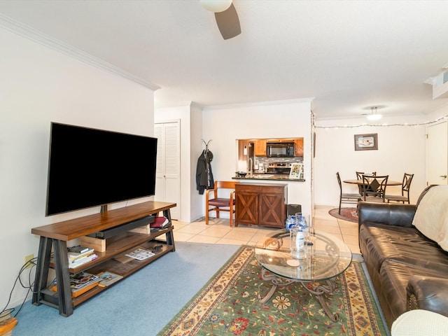 living room featuring light tile patterned floors, ornamental molding, and ceiling fan