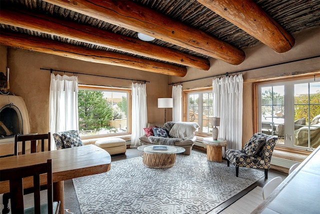 living room with beam ceiling and a healthy amount of sunlight