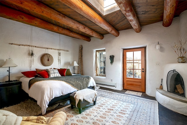 bedroom with beamed ceiling, wood ceiling, baseboard heating, and a skylight