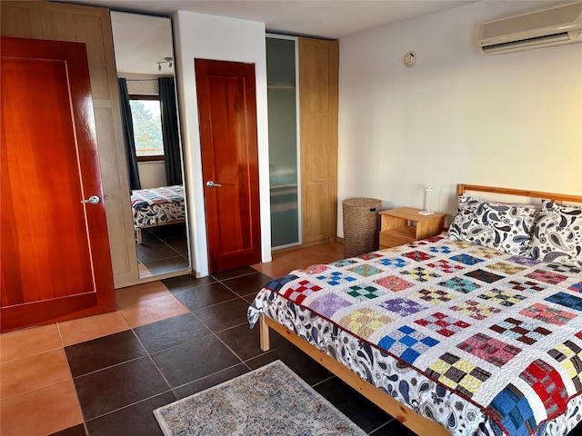 tiled bedroom with a closet and a wall unit AC