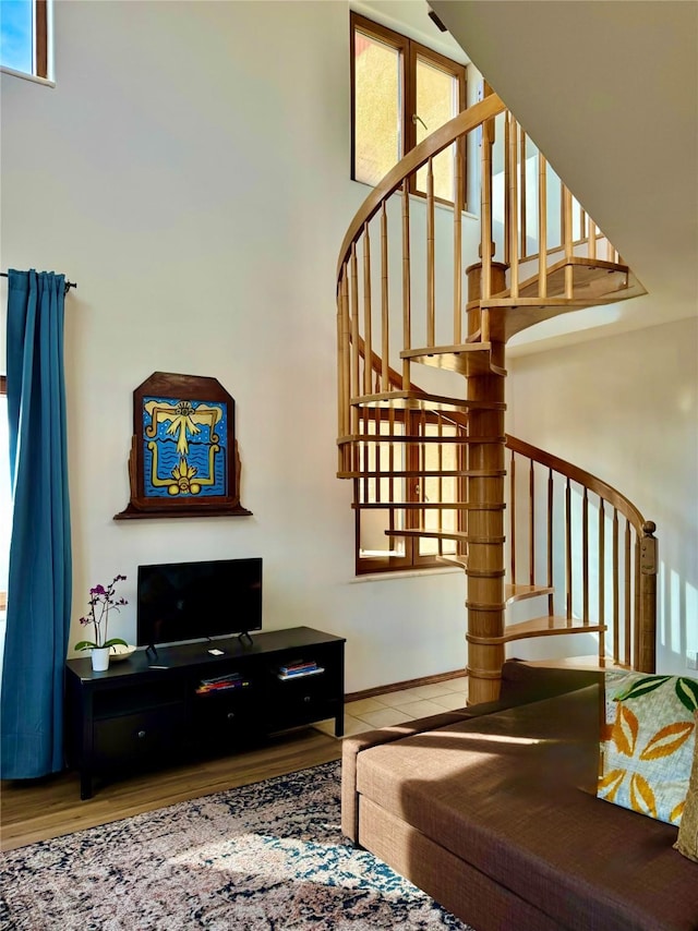 living area with stairway and a high ceiling