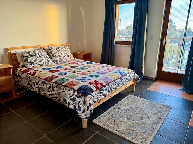 bedroom with dark tile patterned floors