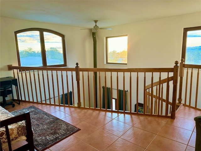 living area featuring ceiling fan, a healthy amount of sunlight, and light tile patterned floors