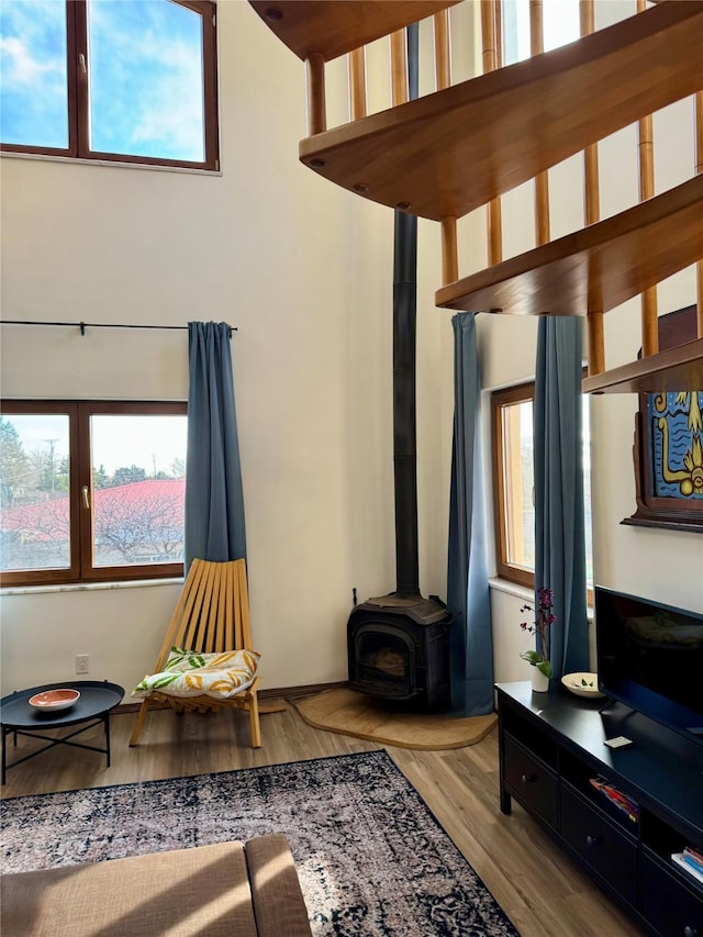 living room featuring a wood stove and wood finished floors