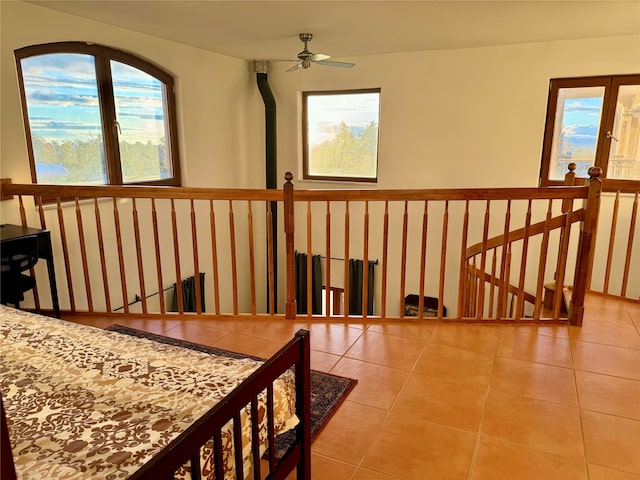 interior space with light tile patterned floors and a healthy amount of sunlight