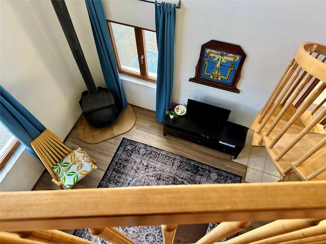 living room featuring a wood stove and wood finished floors