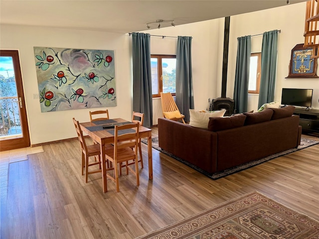 living area featuring light wood-style floors and a wood stove