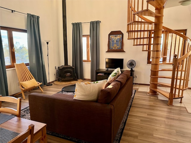 living room with a wood stove and hardwood / wood-style floors