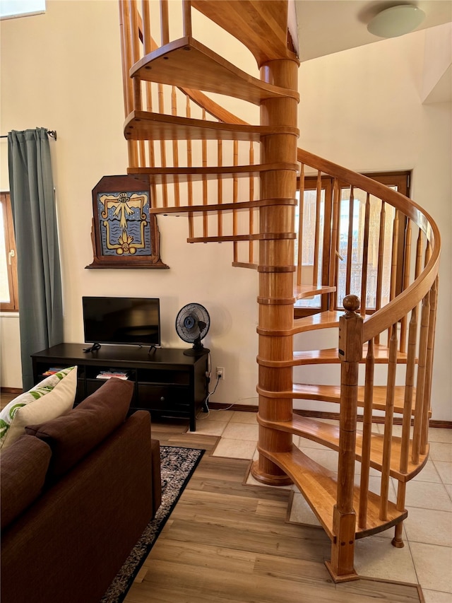 stairs featuring hardwood / wood-style floors