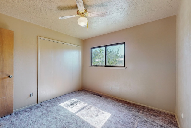 2709 Paseo De Tularosa, Santa Fe, NM 87505 - unfurnished bedroom featuring a closet, carpet, a textured ceiling, and ceiling fan
