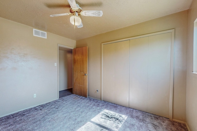 2709 Paseo De Tularosa, Santa Fe, NM 87505 - unfurnished bedroom with a closet, a textured ceiling, carpet flooring, and ceiling fan