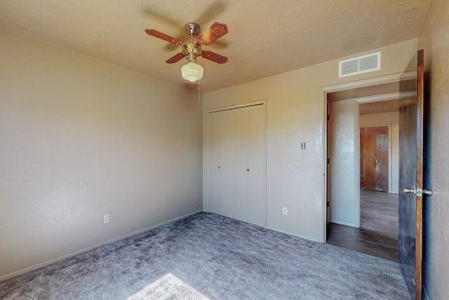 2709 Paseo De Tularosa, Santa Fe, NM 87505 - unfurnished bedroom featuring a closet, a textured ceiling, ceiling fan, and carpet floors