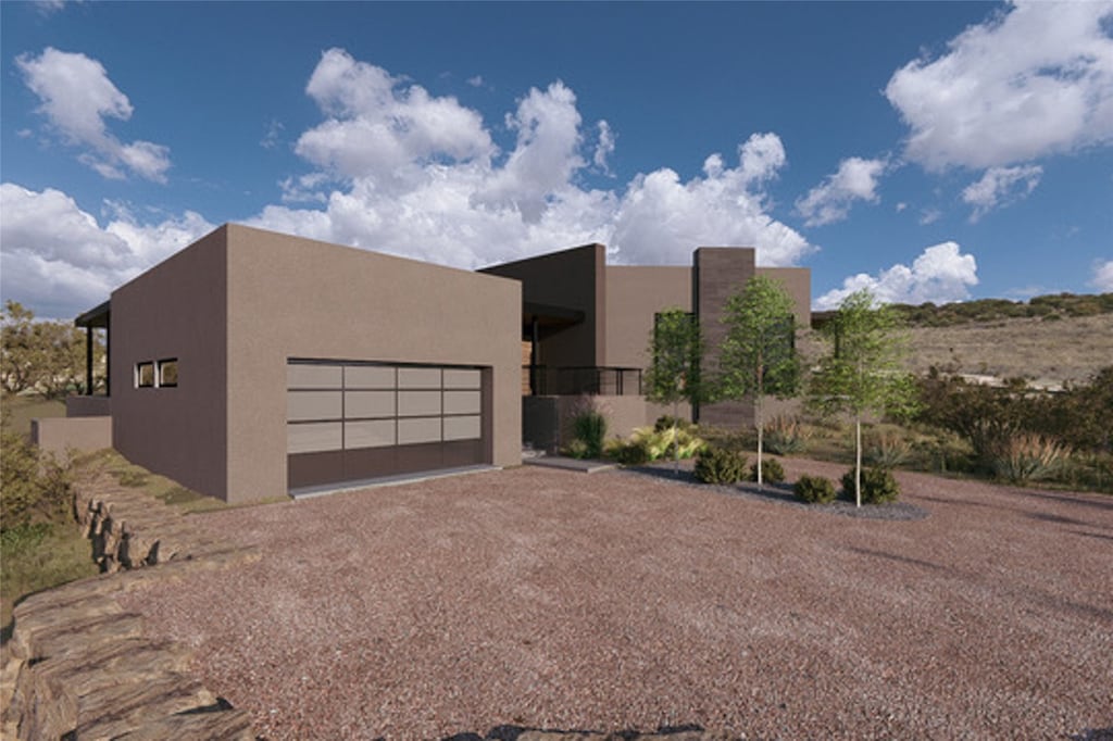 pueblo revival-style home featuring a garage