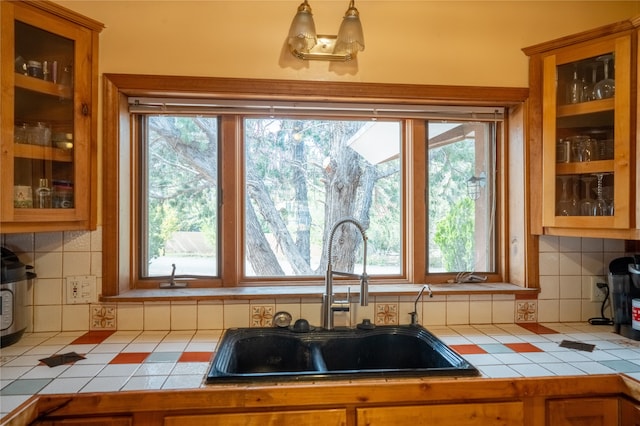 kitchen featuring tile counters, sink, and tasteful backsplash