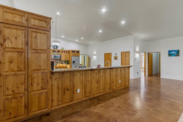 kitchen featuring tasteful backsplash, light stone counters, stainless steel appliances, sink, and vaulted ceiling