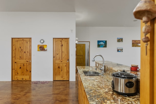 kitchen with sink and light stone counters