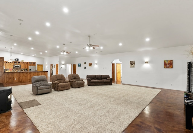 living room featuring concrete flooring and ceiling fan