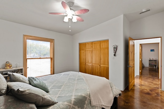 bedroom featuring ceiling fan, vaulted ceiling, and a closet