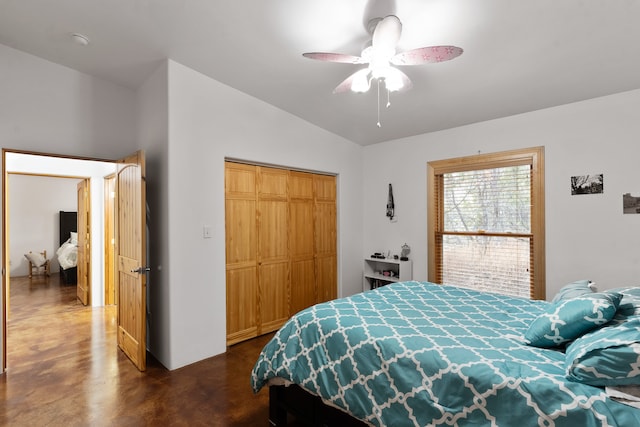 bedroom with a closet, vaulted ceiling, and ceiling fan