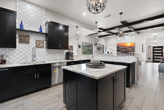 kitchen featuring beamed ceiling, sink, tasteful backsplash, stainless steel dishwasher, and a kitchen island