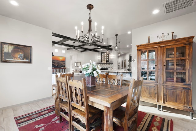 dining space featuring light wood-type flooring and a chandelier