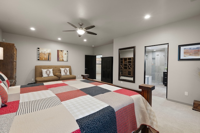 bedroom with ceiling fan, connected bathroom, and light carpet