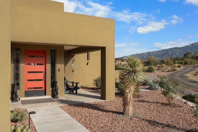 view of exterior entry with a mountain view