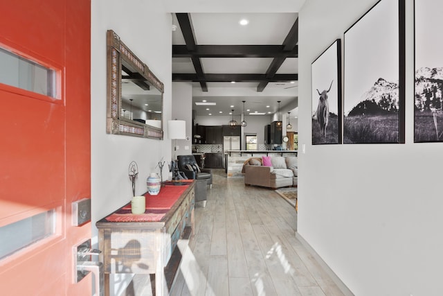 hallway featuring light wood-type flooring, coffered ceiling, and beam ceiling