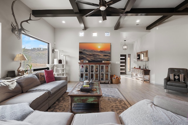 living room featuring beamed ceiling, hardwood / wood-style floors, and ceiling fan