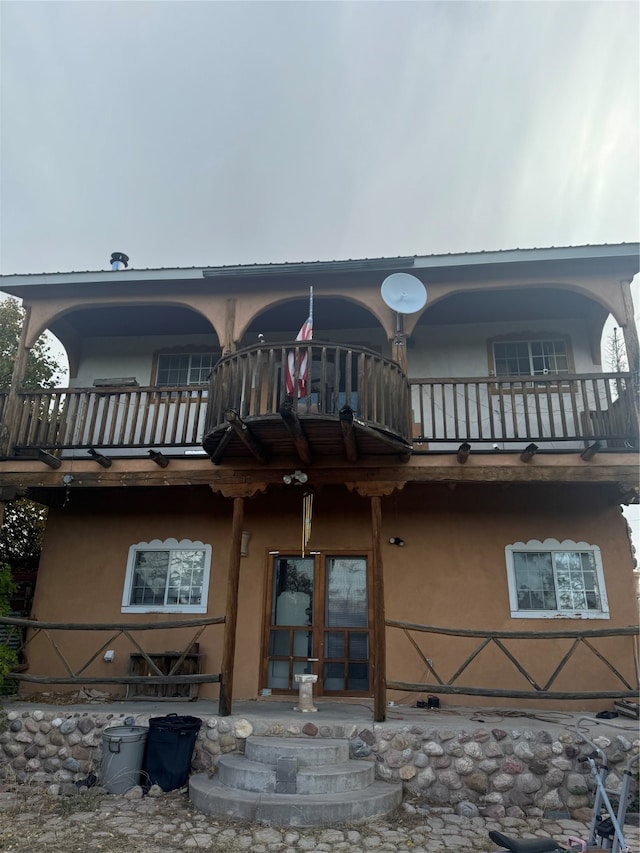 back of house featuring a balcony